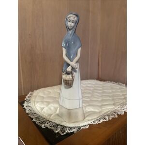 Woman figurine porcelain village lady holding basket Unsigned Vintage